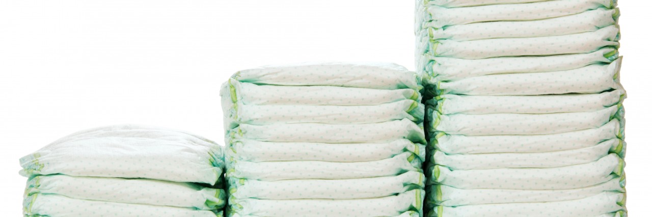 We Need Bigger Diaper Sizes in Supermarkets steps of stacks of diapers isolated on white background