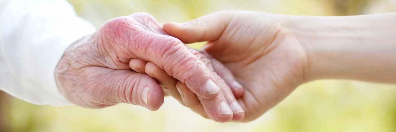 The Value of Caregivers for People With Arthritis Holding hands with a person with arthritis.