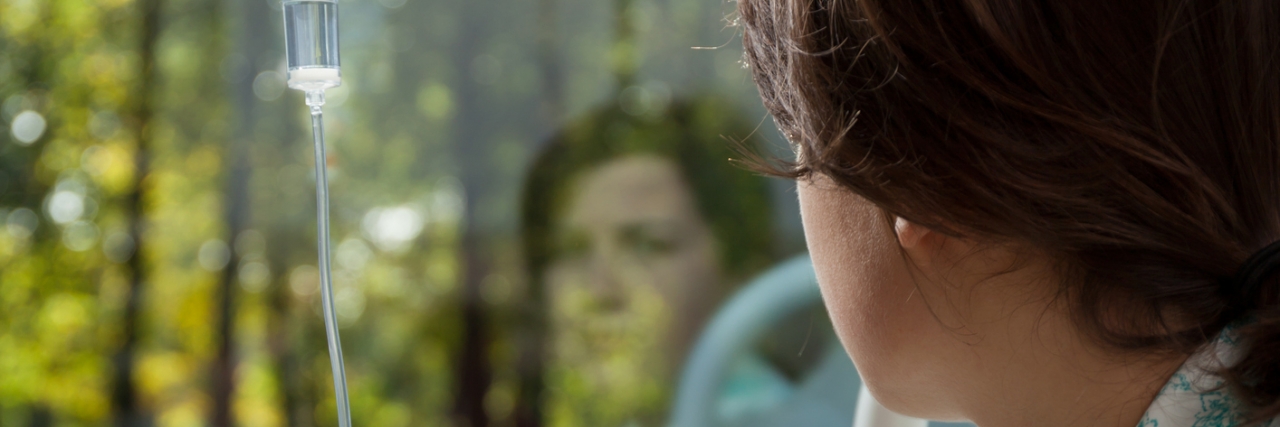 Dating With Chronic Cancer Young woman in hospital looking from the window