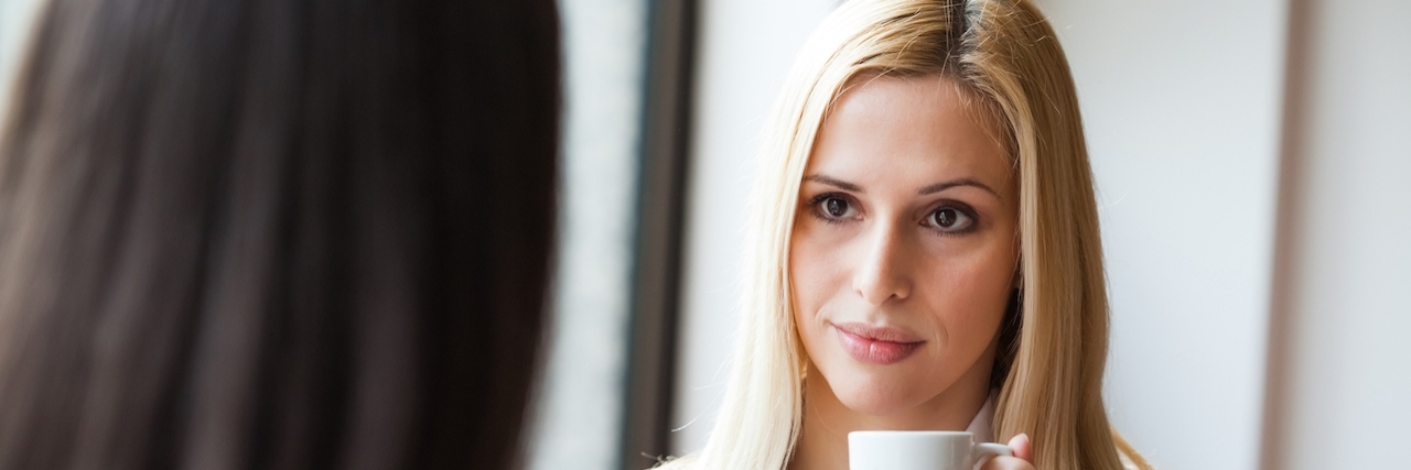 Two women talking in a cafe, photo taken with ambient light