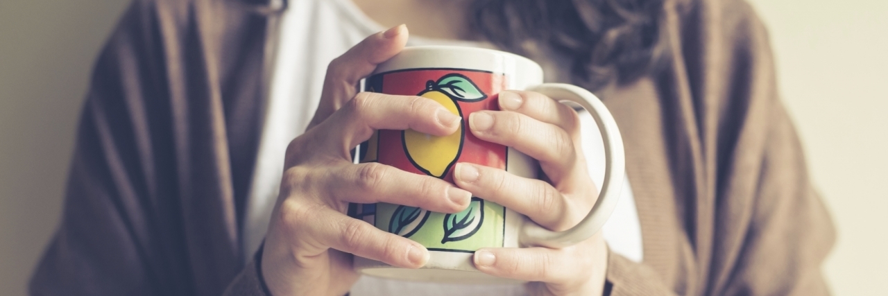 Tips for Recovering From Self-Harm close up of hands woman with cup