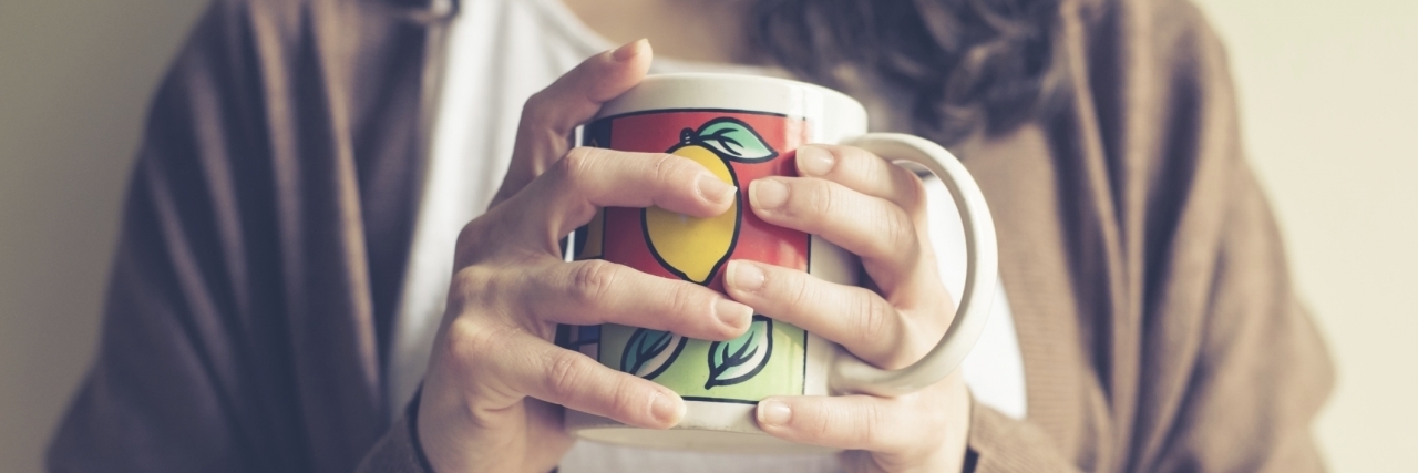 close up of hands woman with cup