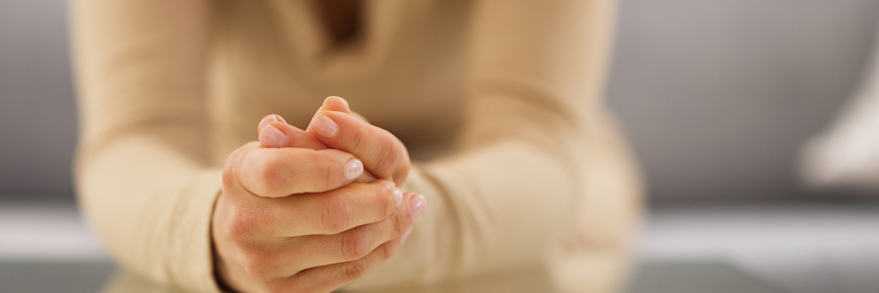 Being Warned About 'Phantom Baby' After Losing a Baby Close-up of woman's hands clasped together on table