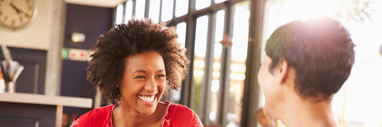 Keeping Friendships When You Have a Chronic Illness Two female friends talking at a coffee shop