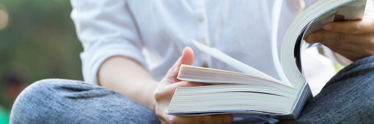 OCD Making It Hard to Read woman sitting cross-legged and reading a book