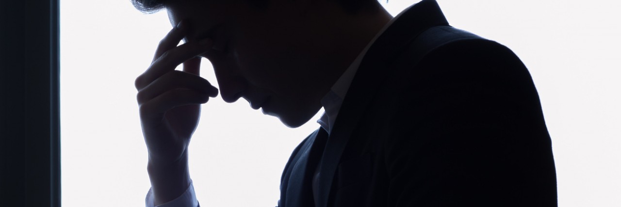 Silhouette of stressed man wearing a suit