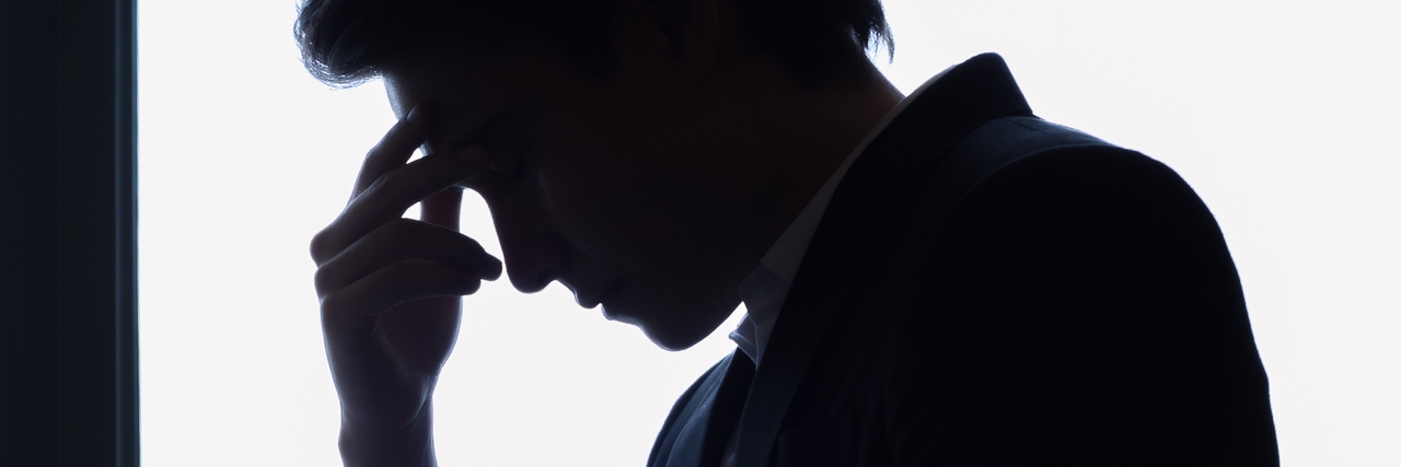 When Anxiety and Depression Feel Like a Tornado Inside Your Head Silhouette of stressed man wearing a suit