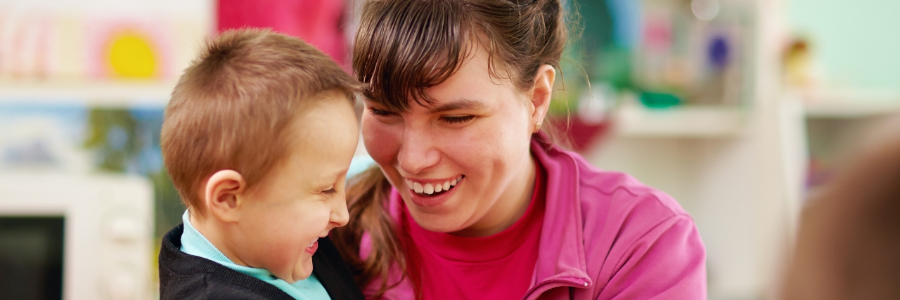 Students With Disabilities Comfort Teacher With Systemic Lupus cheerful kids with disabilities in rehabilitation center