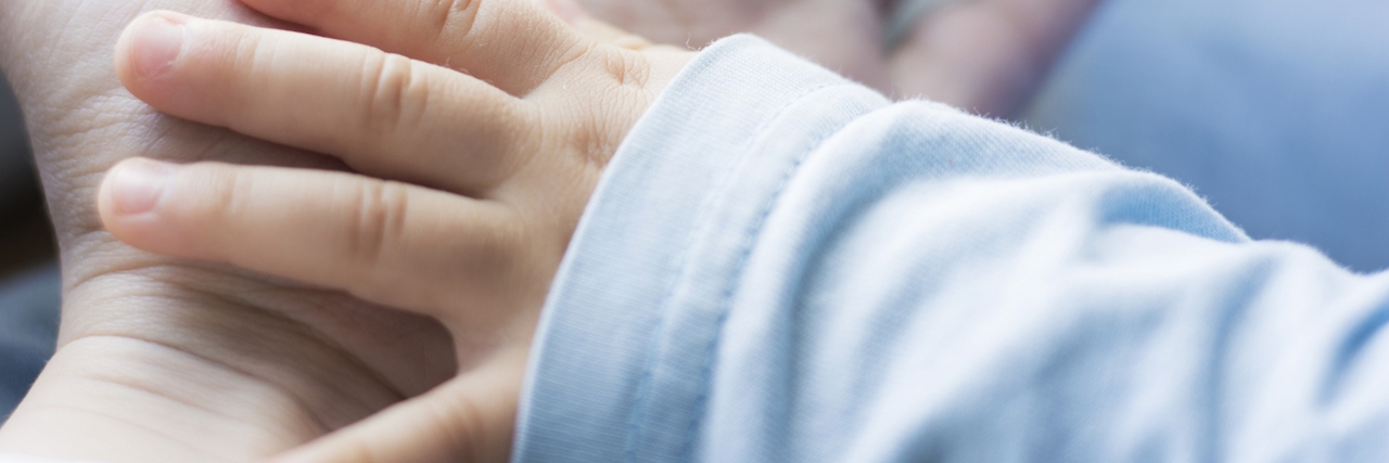 Was My Birth Traumatic? PTSD After Childbirth Baby's hand over mother's hand