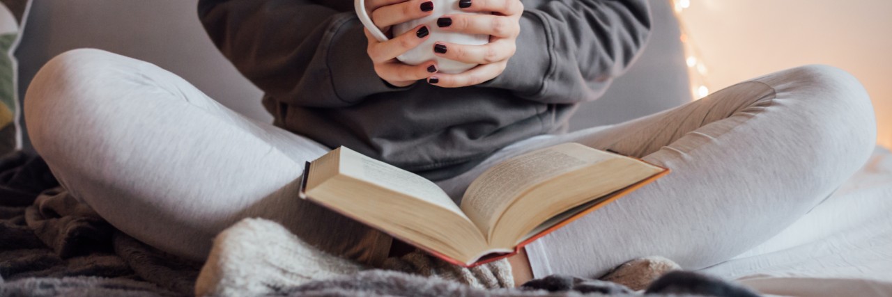 How Books Help Me Manage My Anxiety During High School girl reading a book in bed