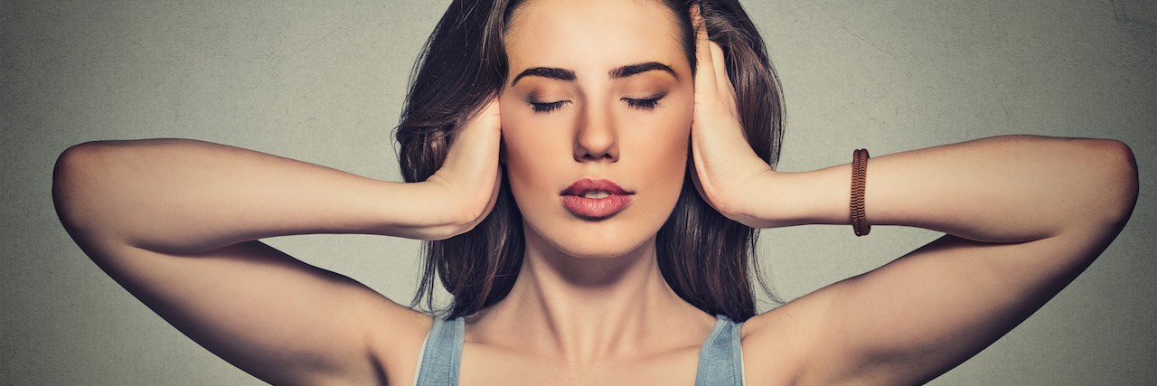 A Conversation With My Anxiety oman covering with hands her ears