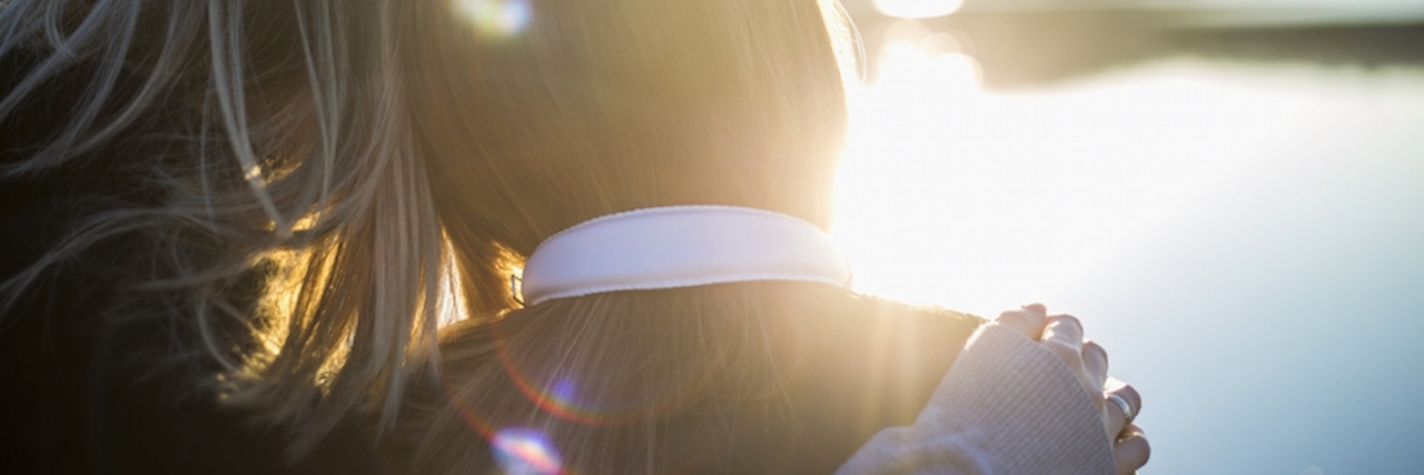 Ways to Show Support to People With PTSD Two women with their arms around each other, looking at a sunny landscape
