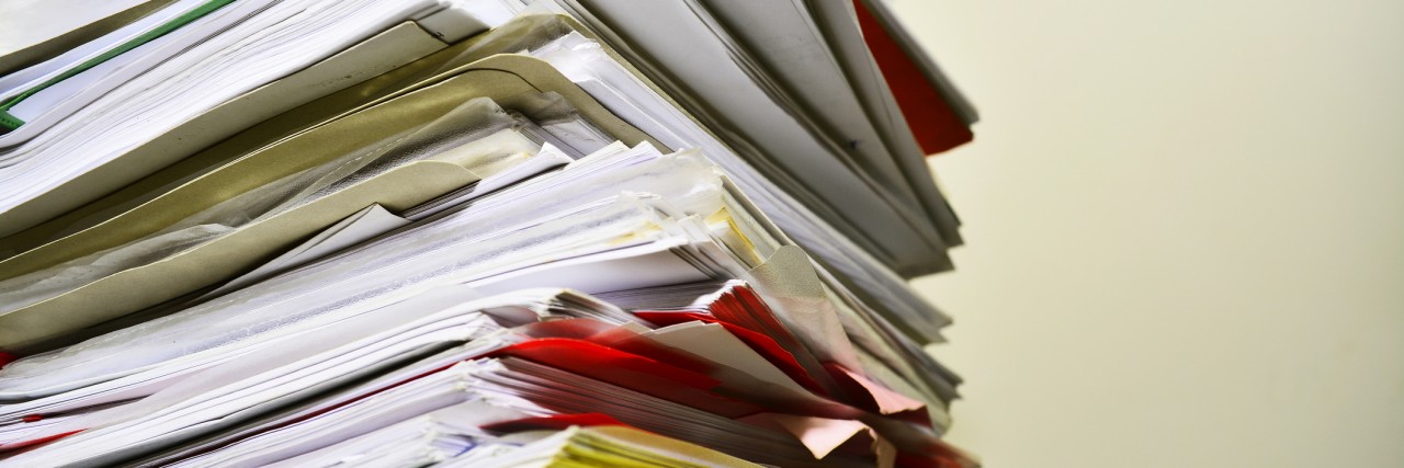 Responding to a Claim Denial for Social Security Disability Benefits Stack of files on desk.