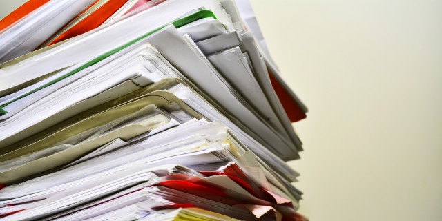 Stack of files on desk.