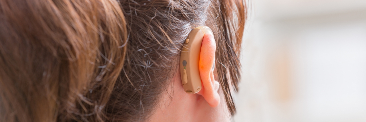 Joking About Hearing Loss woman wearing hearing aid