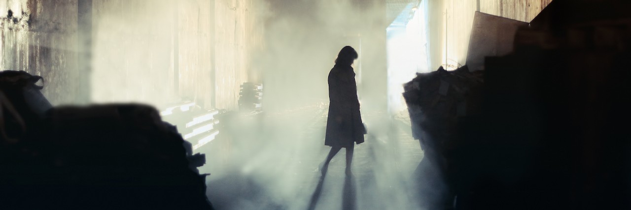 Treating My Eating Disorder, POTS and Kidney Disease A lone wonan stands in a misty underground tunnel