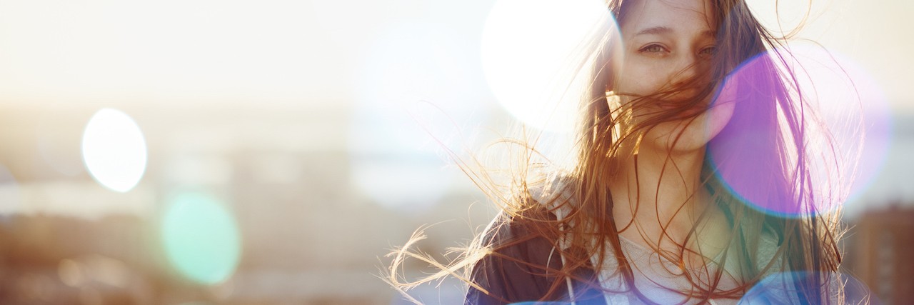 What Family and Frieinds Should Understnd About Anxiety Young Woman Standing in Sunset Light