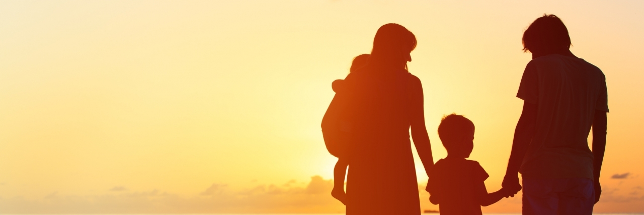 happy family with two kids at sunset