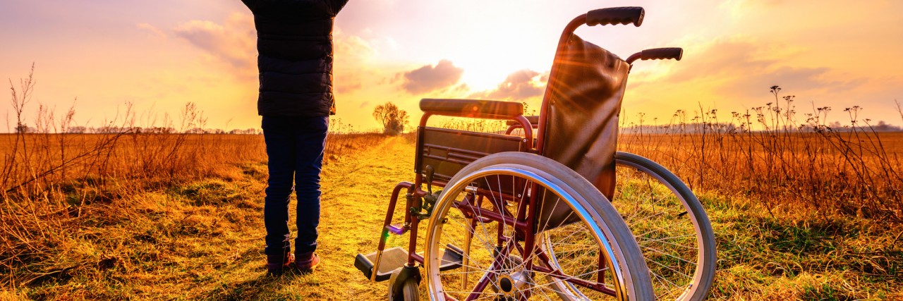 Living With Dercum's Disease and Being an Inspiration Miracle recovery: young girl gets up from wheelchair and raises hands up. Overjoyed young girl standing up from a wheelchair outdoors. Shot in meadow. Recovery concept