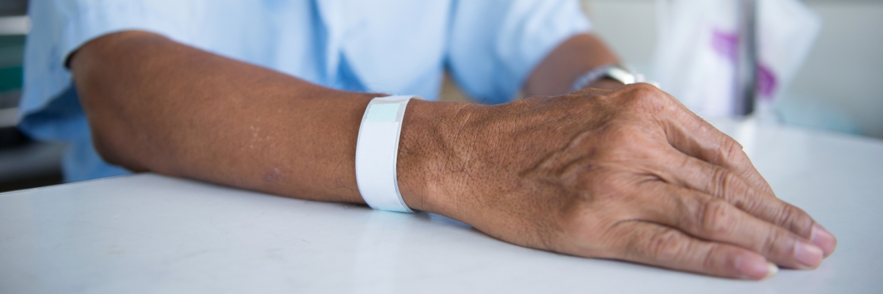 Learning to Accept Help With a Disability and Chronic Illness Patient with IV drip and hand tag in a hospital