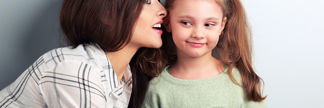 Deaf Mom's Response to the Claim Her Hearing Child Is an Interpreter mom whispering to her daughter