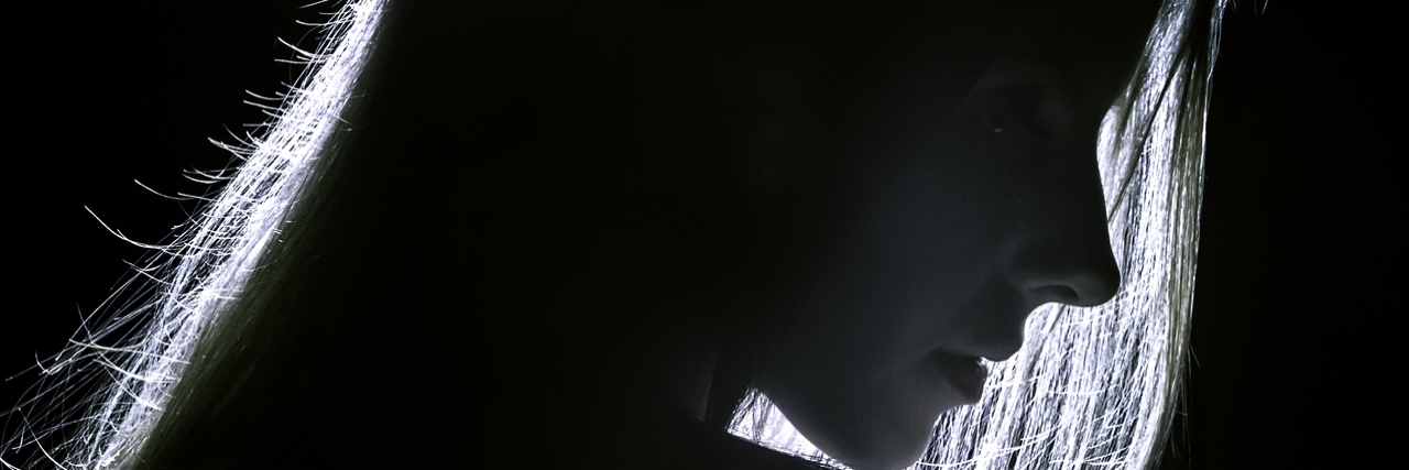 The Letter I Need to Read When I Am in a Dark Place silhouette of woman in dark room with light around her