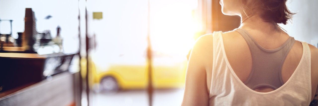 Symptoms of Cyclic Vomiting Syndrome People Don't See woman sitting at table facing window