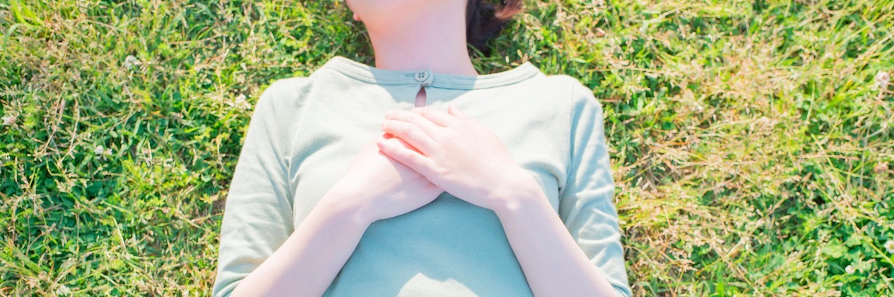 Postpartum Anxiety: Dealing With Excessive Worry woman relaxing in the park