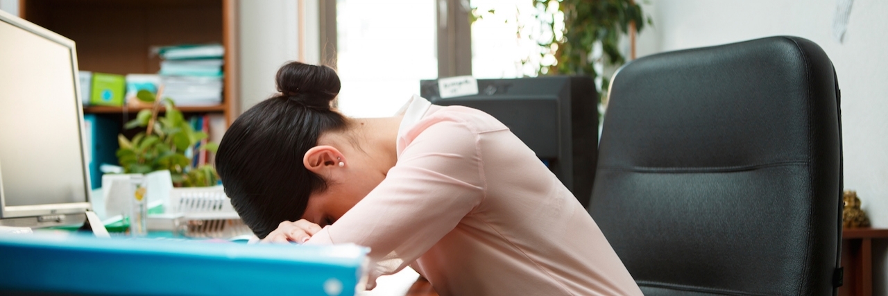 Living With Adrenal Insufficiency: What to Know Tired businesswoman sleeping on the desk.