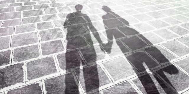 shadows of two people holding hands