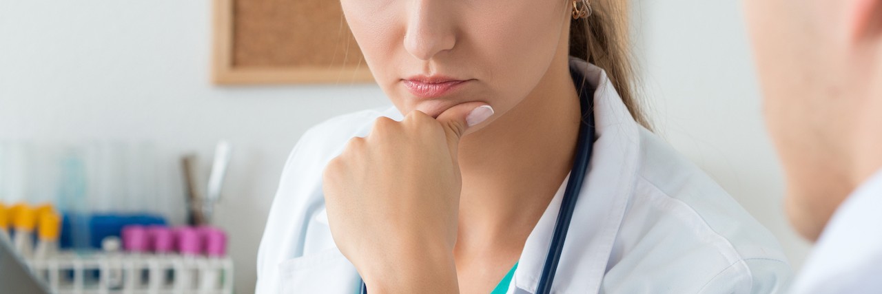 What Stiff-Person Syndrome Specialists Should Know About Patients Young female doctor and her male colleague discussing x-ray imag