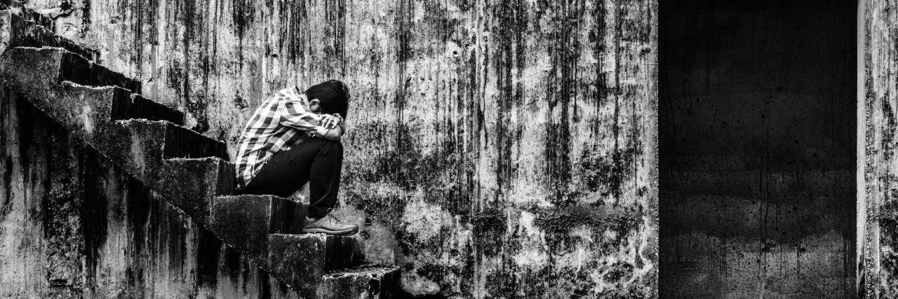 Depression Is My Roommate: How I Cope depressed teenager sitting on stair in creepy abandoned building, darkness concept
