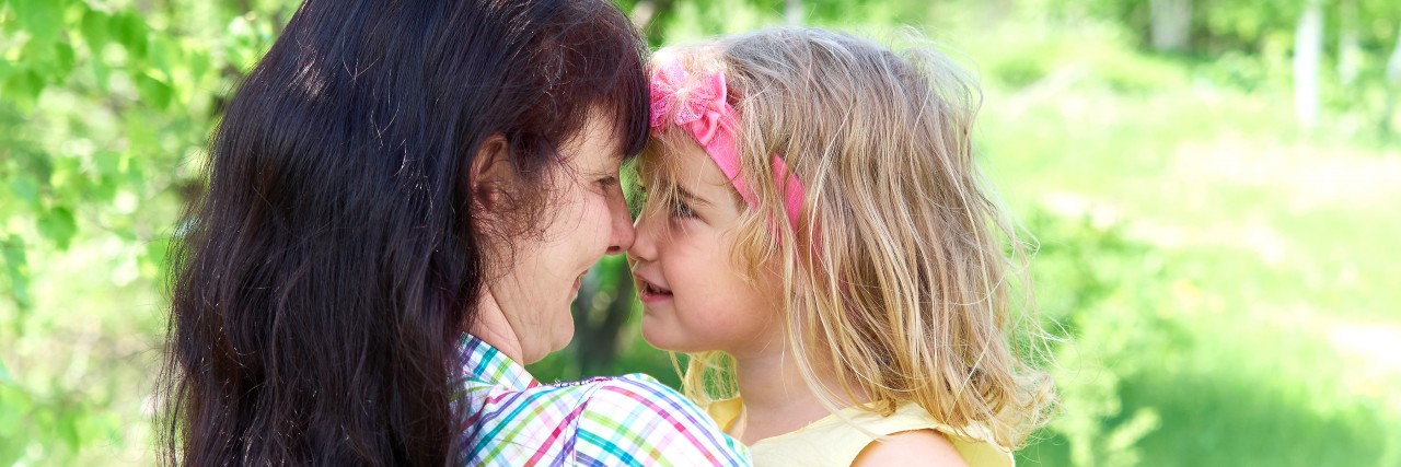 mom playing with daughter outside