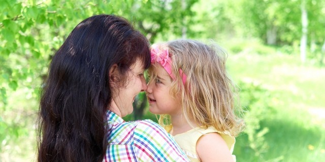 mom playing with daughter outside