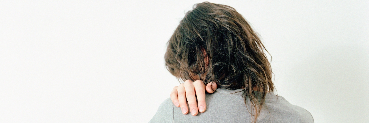 How to Explain Borderline Personality Disorder to Loved Ones woman with her hand on her shoulder, looking back