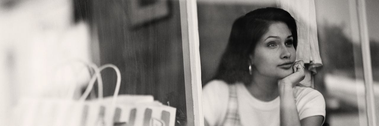 Woman looking out cafe window