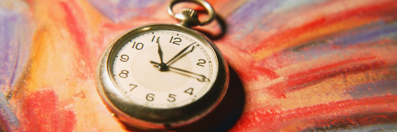 Depression and Losing Time a pocket watch lying on a painting of a hand