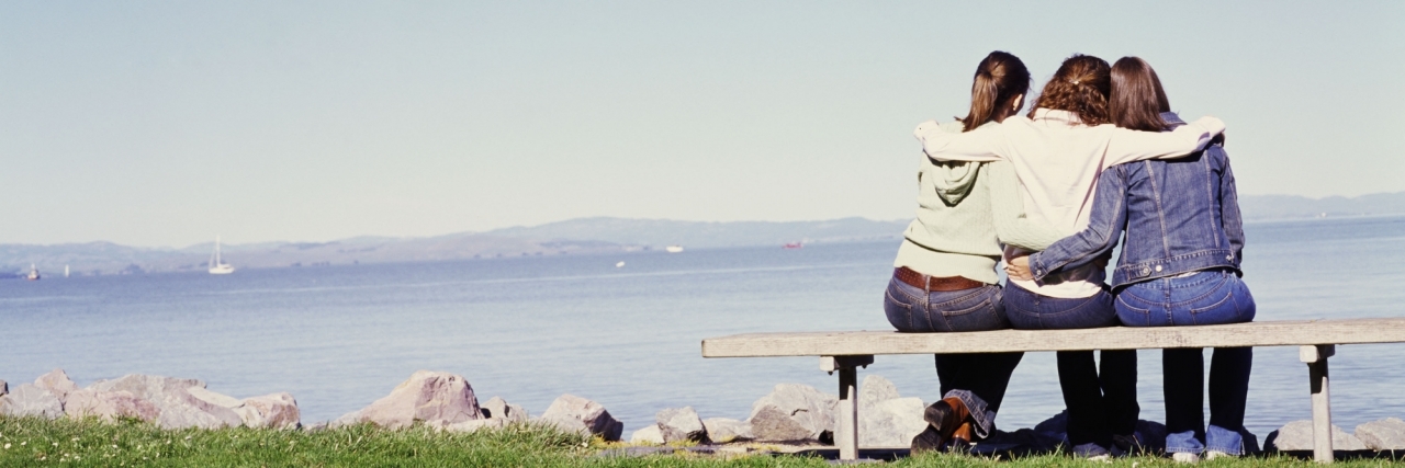 What to Know If You Were Diagnosed With Inflammatory Bowel Disease three friends with arms around each other on bench