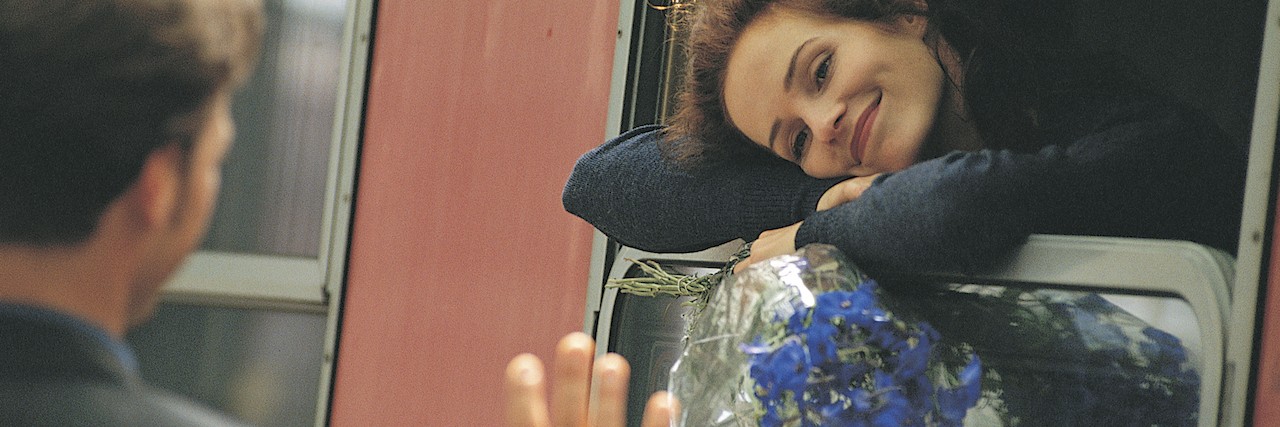 Meaning of 'I'll See You Tomorrow' to Someone With a Mental Illness a man waving goodbye to a woman, who's smiling on a train