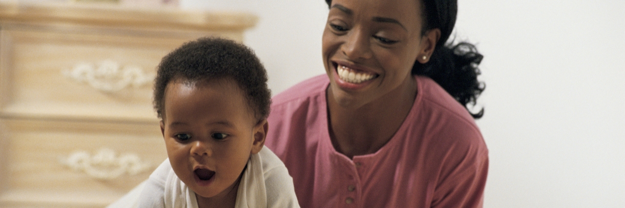 How to Cope With Postpartum Depression as a New Mom Woman with crawling baby