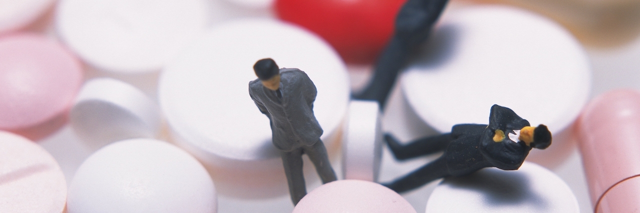 What Happens When I Stopped Taking My Depression Medication Three male figurines among capsules and tablets