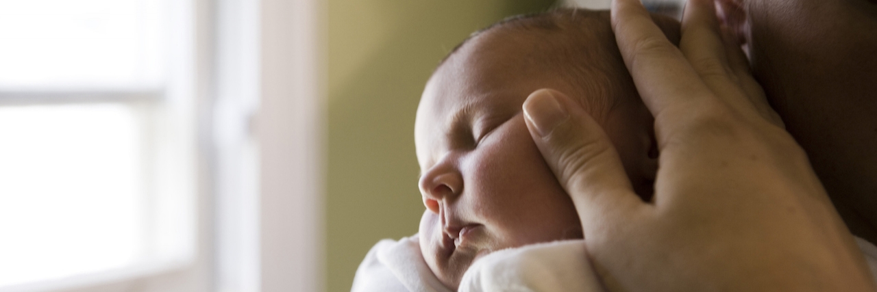 What a New Mom With Postpartum Depression Needs to Hear young woman holding her baby