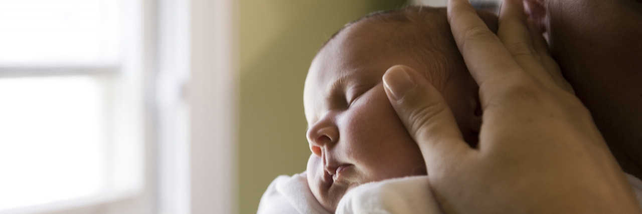 young woman holding her baby