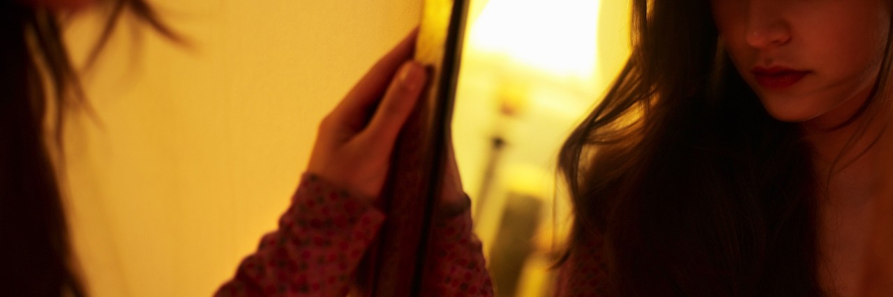 Anorexia Relapse and Body-Checking: 'Sitting Shiva' for Your Body Woman looking in mirror
