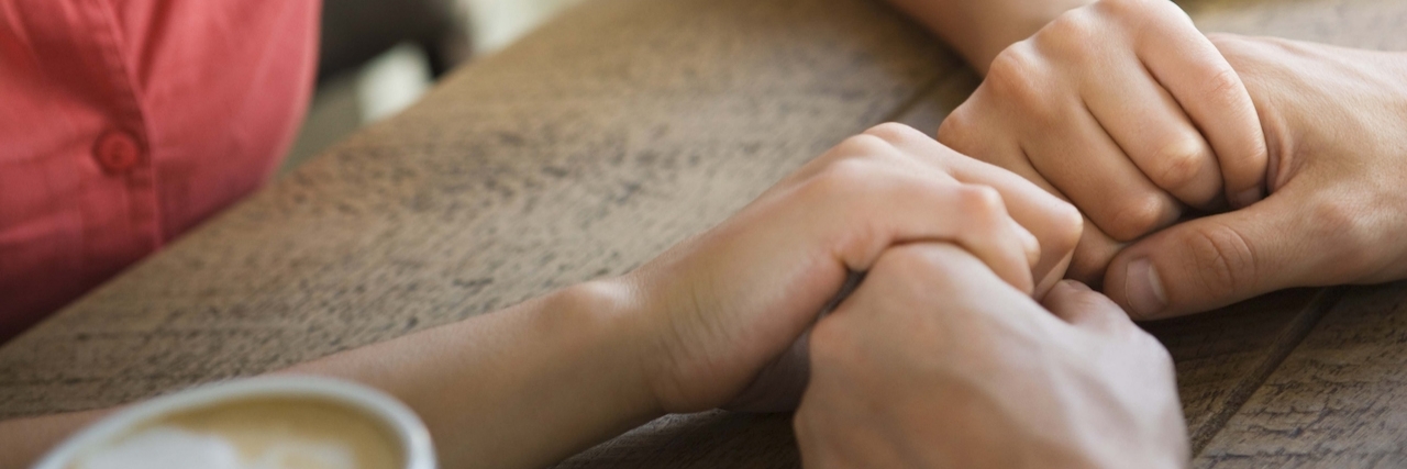A Letter to a Friend With Depression Two people holding hands at table