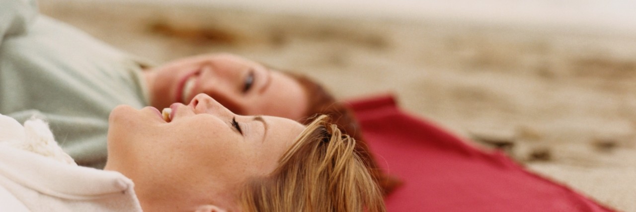 two women talking on the beach