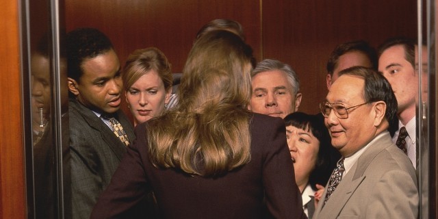 Woman Entering Crowded Elevator