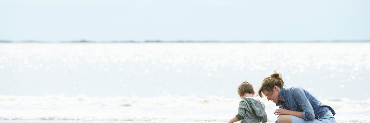 Talking With Others About Child's Sensory Processing Disorder Mother and son playing on the shore of a beach