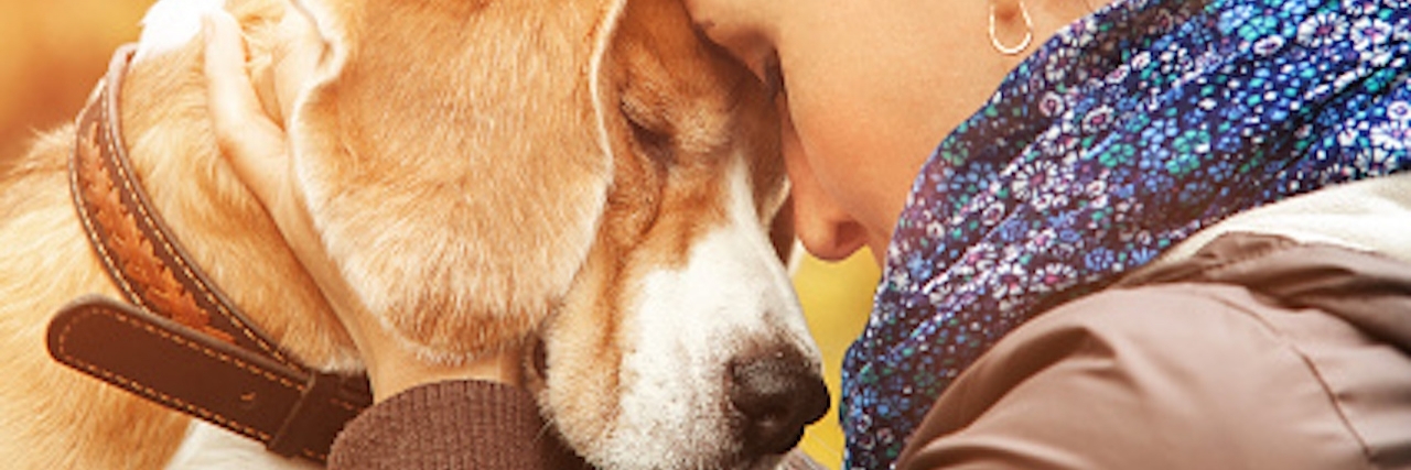 Woman and dog touch faces