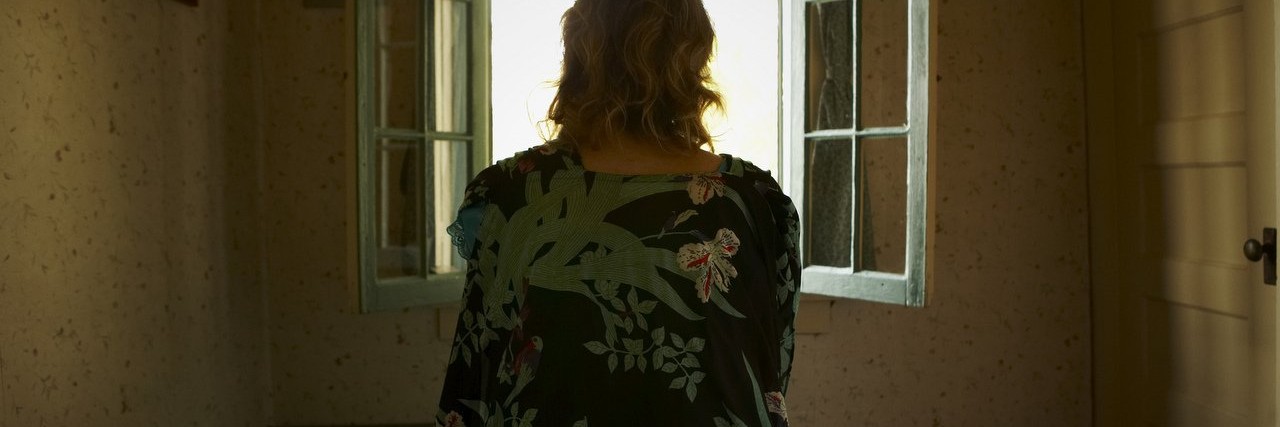 How I Define Hope as a Person With Chronic Lyme Disease Woman looking out a window